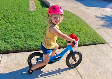 child on balance bike on holiday in Somerset