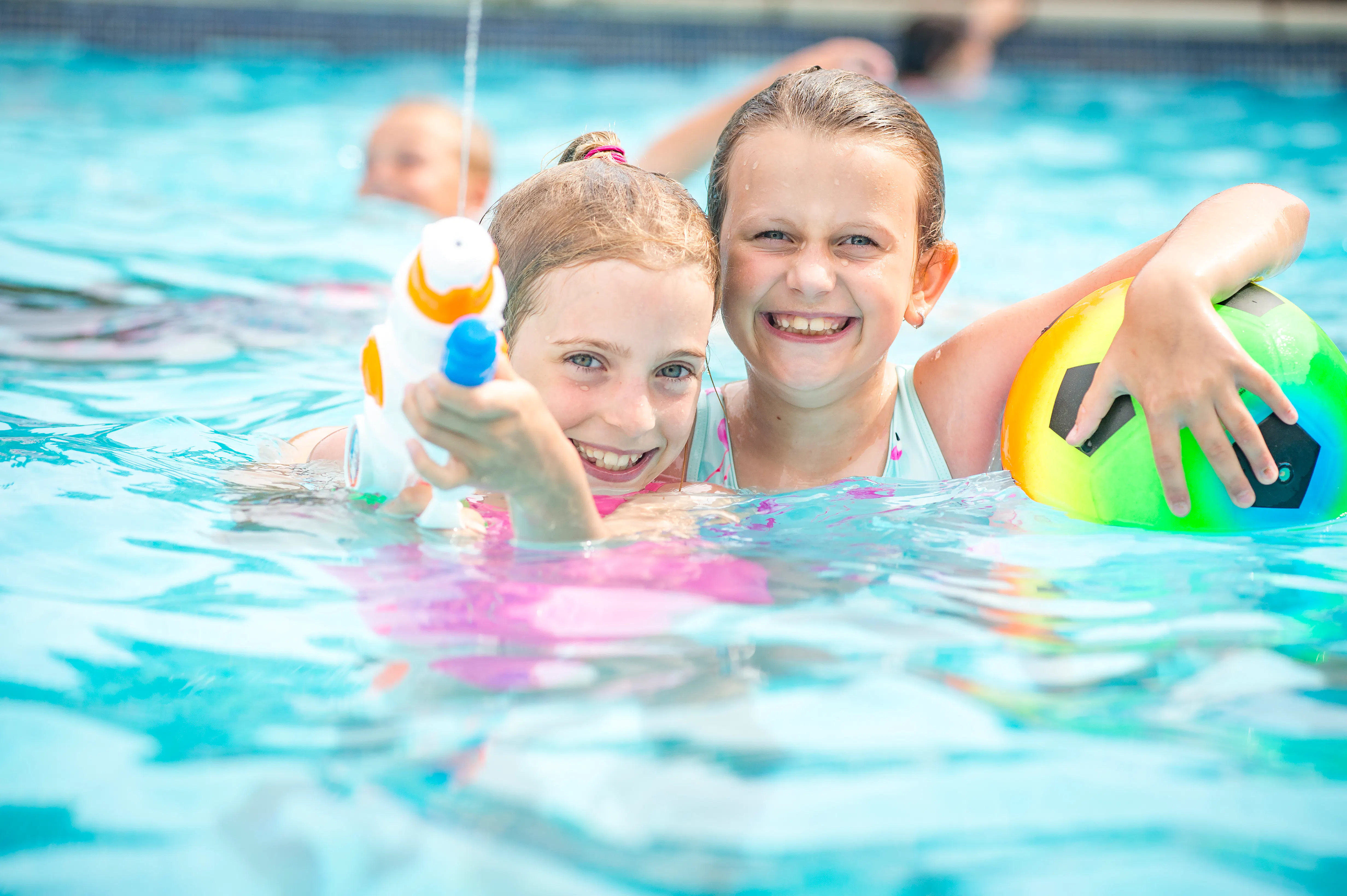 Girls in swimming pool on holiday